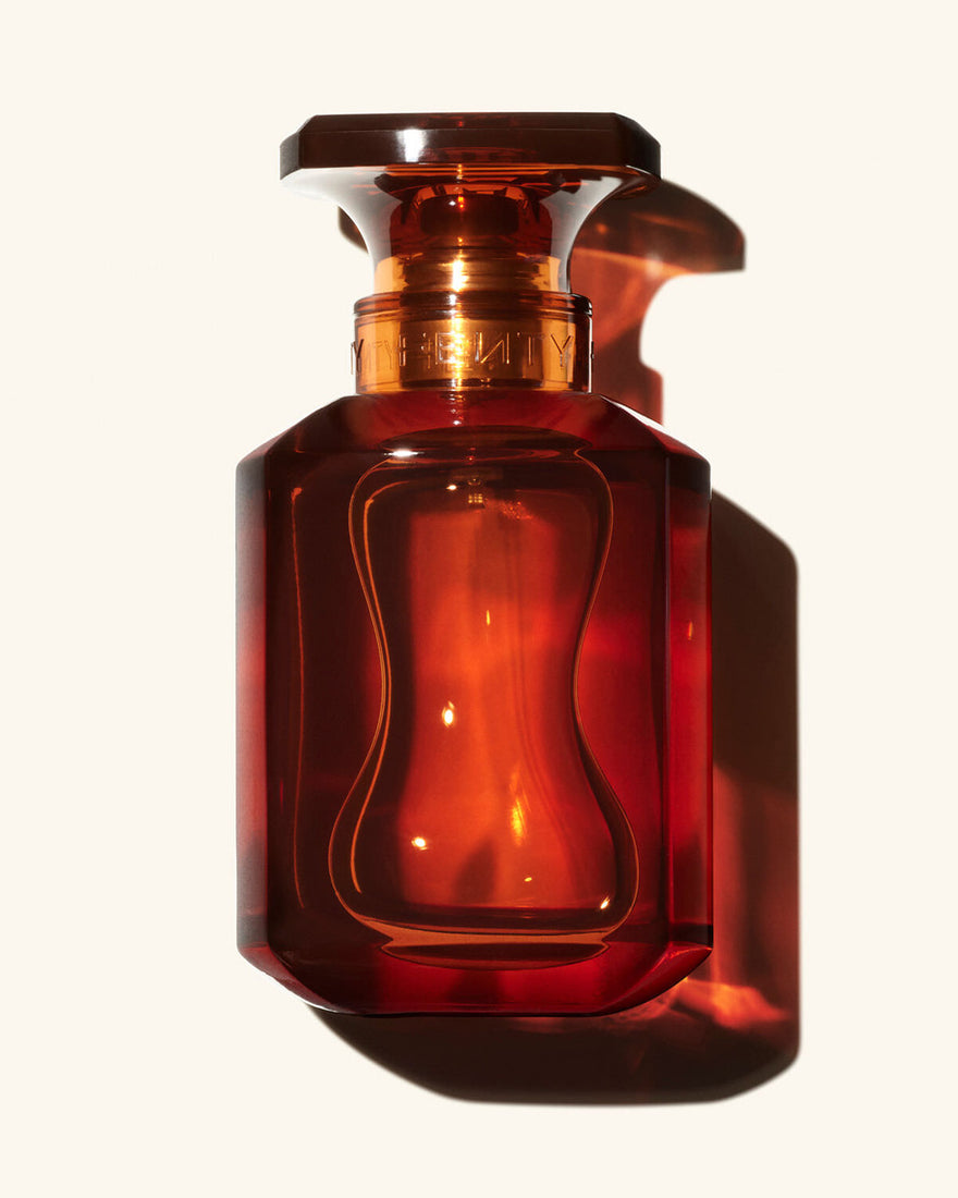 75ml Bottle of Fenty Eau de Parfumon a cream colored background.