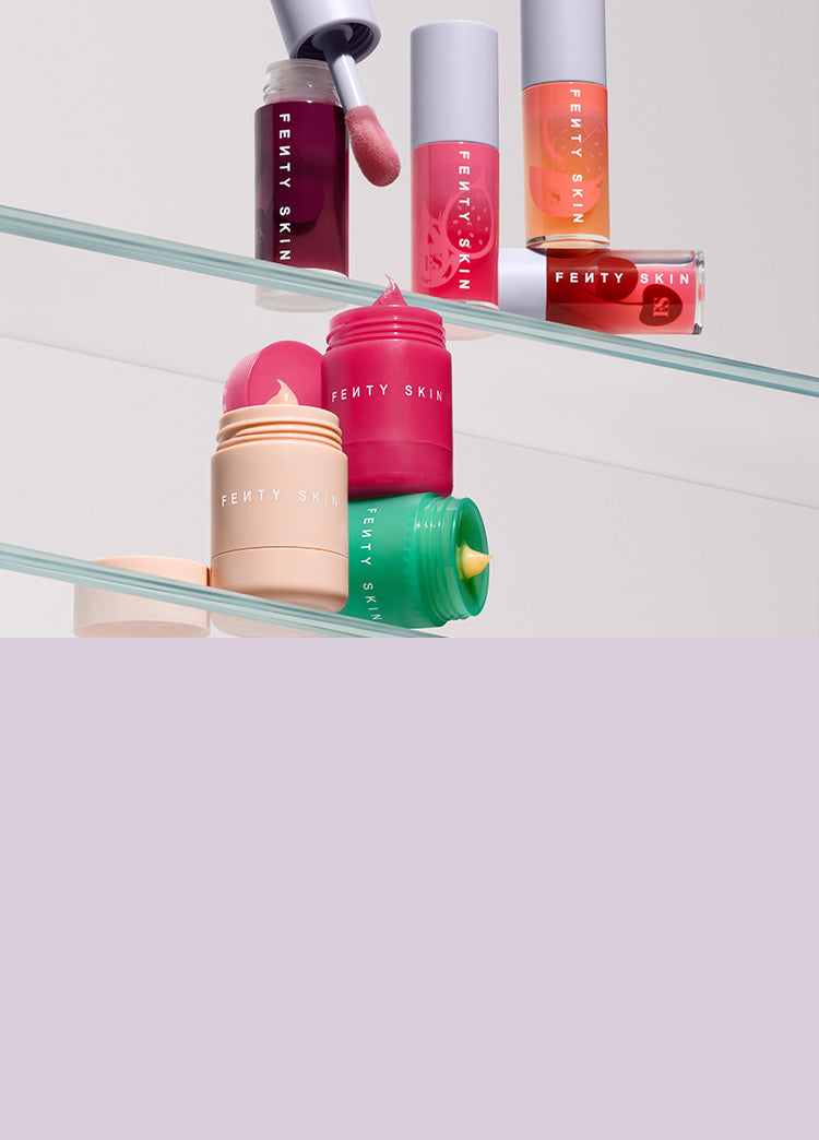 Fenty Skin Lip Treatment collection of Fenty Skin Fenty Treatz Lip Oil and Plush Pudding Lip Mask on clear shelves.