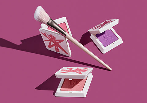 Fenty Beauty Fenty Cheeks Suede Powder Blush open products and Blush Brush 155 on a fuchsia background.